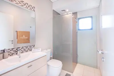 a bathroom with a toilet and a sink and a shower at Gorgeous 3BR Townhouse with Private Garden in Dubai