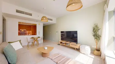a living room with a couch and a table at The Point Tower - Vibrant One Bed in Marina in Dubai