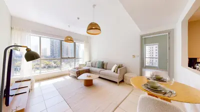 a living room with a couch and a table at The Point Tower - Vibrant One Bed in Marina in Dubai