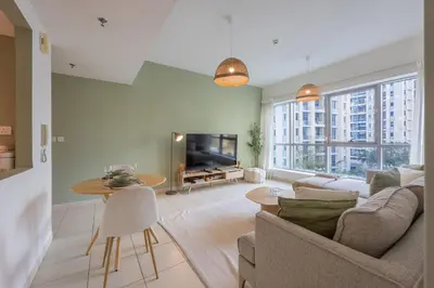 a living room with a couch and a tv at The Point Tower - Vibrant One Bed in Marina in Dubai