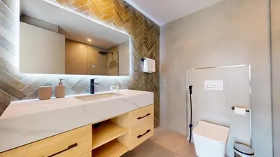 a bathroom with a sink and a mirror and a shower at The Point Tower - Vibrant One Bed in Marina in Dubai