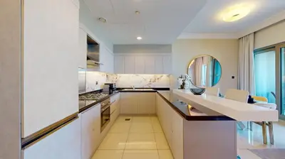 a kitchen with white cabinets and a sink at The Signature - Two Bedroom in Downtown Dubai in Dubai