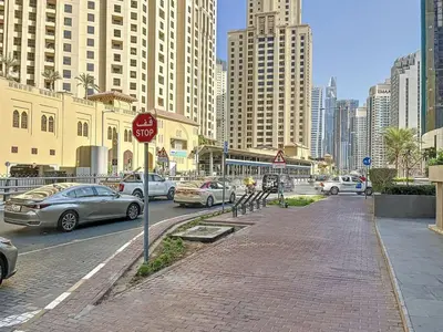 a stop sign on the side of a street with cars at Bay Central 1 - One Bed with Stunning Marina View in Dubai