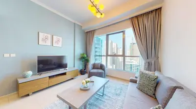 a living room with a couch and a tv at Bay Central 1 - One Bed with Stunning Marina View in Dubai