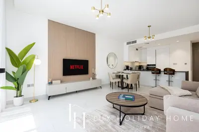 a living room with a couch and a table at LUX 2BR Lagoon View District One, 10 to 15 min Burj Khalifa in Dubai