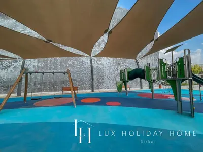 a playground at a holiday home at LUX 2BR Lagoon View District One, 10 to 15 min Burj Khalifa in Dubai