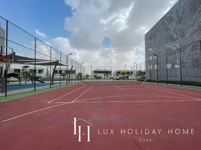 a tennis court with the words uk holiday home at LUX 2BR Lagoon View District One, 10 to 15 min Burj Khalifa in Dubai