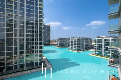 a view of a pool in a city with tall buildings at LUX 2BR Lagoon View District One, 10 to 15 min Burj Khalifa in Dubai