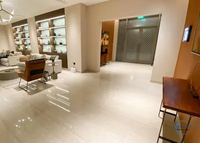 a living room with a couch and a table and chairs at Stylish 2BR Escape 2 Balconies Pool View in Dubai