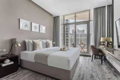 a bedroom with a large white bed and a large window at Frank Porter - Damac Prive A in Dubai