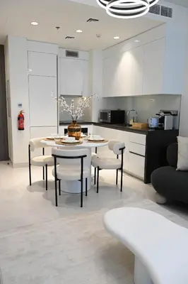 a kitchen with a table and chairs in a kitchen at 610 lagoon views in Dubai