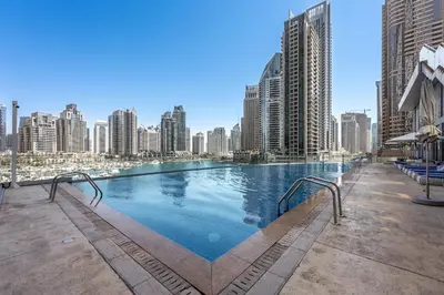 a large swimming pool on top of a city skyline at Stayis -Studio in Twisted Tower Dubai Marina in Dubai