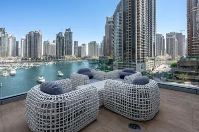 a table and chairs on a balcony with a view of a city at Stayis -Studio in Twisted Tower Dubai Marina in Dubai