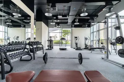 a gym with rows of treadmills and machines at FIRST CLASS 1BR Luxurious DIFC Retreat in Dubai