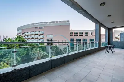 a balcony with a view of a building at Waterfront 2BR Apartment with Assistant Room in Dream Palm Residence, Palm Jumeirah by Deluxe Holiday Homes in Dubai