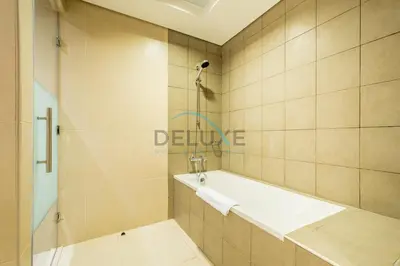 a bathroom with a shower and a bath tub at Waterfront 2BR Apartment with Assistant Room in Dream Palm Residence, Palm Jumeirah by Deluxe Holiday Homes in Dubai
