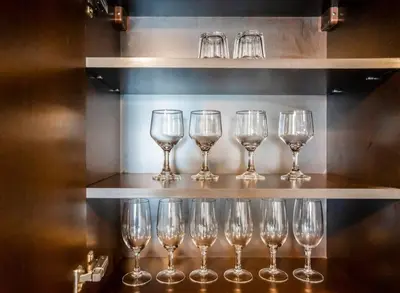 a row of wine glasses sitting on a shelf at Duplex Suite in 5-Star Movenpick Hotel in Dubai