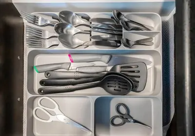 a drawer full of utensils in a refrigerator at Duplex Suite in 5-Star Movenpick Hotel in Dubai