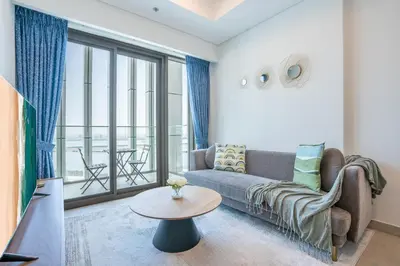 a living room with a couch and a table at RH - Stunning Canal View 01 BR with Top amenities, newly furnished in Dubai
