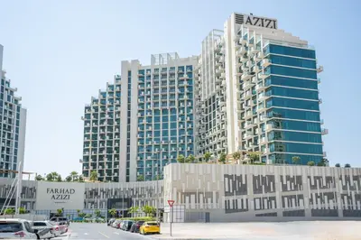 a large building in front of a parking lot with cars at RH - Stunning Canal View 01 BR with Top amenities, newly furnished in Dubai
