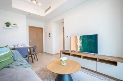 a living room with a couch and a table at RH - Stunning Canal View 01 BR with Top amenities, newly furnished in Dubai