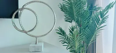 a mirror on a table next to a plant at Bright & Cozy 1br Jvc Balcony Free Parking in Dubai