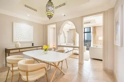 a dining room with a table and chairs and a bathroom at Souk Al Bahar Home with direct Dubai Mall Access in Dubai