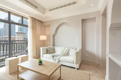 a living room with a couch and a table at Souk Al Bahar Home with direct Dubai Mall Access in Dubai