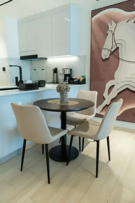 a dining room with a table and chairs in a kitchen at Chic Comfort - Stylish One-Bedroom in Dubai