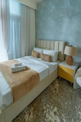 a bedroom with a large bed and a window at Nasma Luxury Stays - Dreamy Getaway Unwind in a Modern Dubai Studio in Dubai