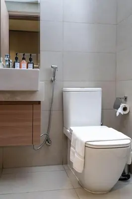 a bathroom with a white toilet and a sink at Nasma Luxury Stays - Dreamy Getaway Unwind in a Modern Dubai Studio in Dubai