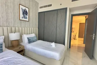 a bedroom with two beds and a sliding door at Relaxing 2BR Escape with Private Pool Samana GA by Vibel in Dubai