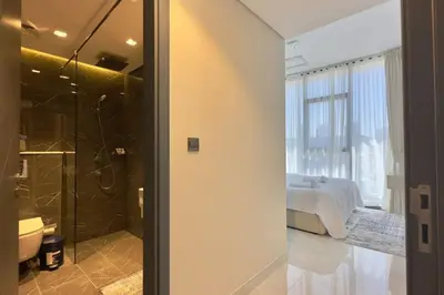 a bedroom with a bed and a bathroom with a shower at Relaxing 2BR Escape with Private Pool Samana GA by Vibel in Dubai