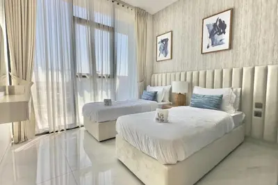 a bedroom with two beds and a large window at Relaxing 2BR Escape with Private Pool Samana GA by Vibel in Dubai