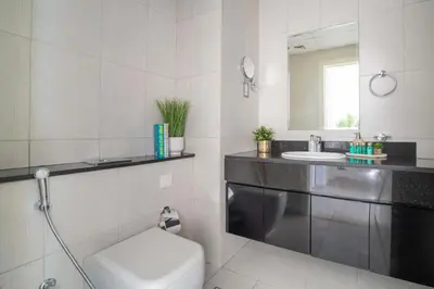 a bathroom with a sink and a toilet and a mirror at Frank Porter - Damac Ghalia Tower - Studio in Dubai