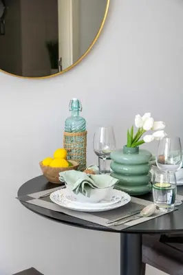 a table with a plate of food and a mirror at Frank Porter - Damac Ghalia Tower - Studio in Dubai