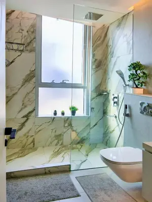 a bathroom with a shower with a toilet and a window at Luxurious Studio Marina View Condor Marina Star in Dubai