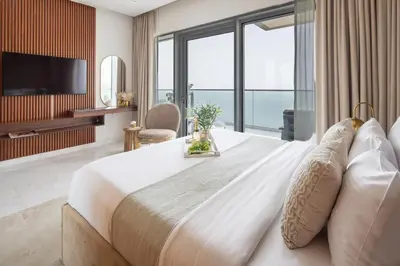 a bedroom with a large bed with a large window at Frank Porter - The One JBR in Dubai
