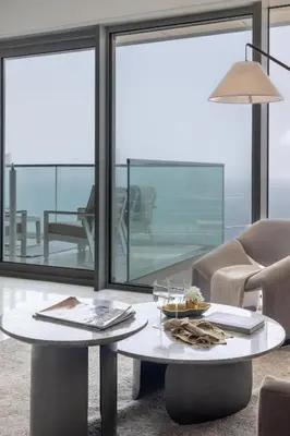 a living room with a table and a chair at Frank Porter - The One JBR in Dubai
