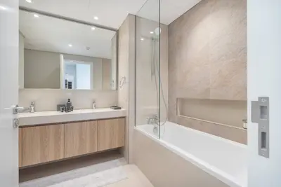 a bathroom with a tub and a sink and a shower at Downtown Views Open Burj View 34th Floor 2BD in Dubai