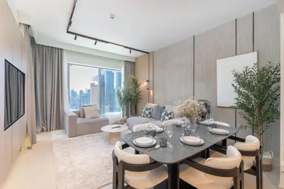 a living room with a table and chairs and a couch at Downtown Views Open Burj View 34th Floor 2BD in Dubai