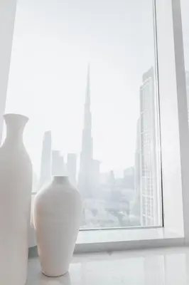 two white vases sitting on a window sill at Luxuriöses Apartment mit Burj Khalifa View in Dubai