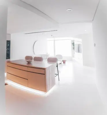 a white room with a desk and chairs in it at Luxuriöses Apartment mit Burj Khalifa View in Dubai