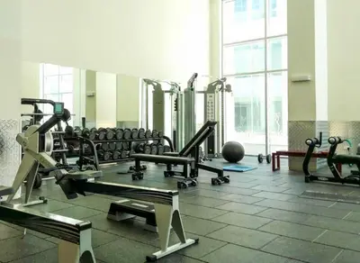 a gym with a lot of treadmills and machines at Luxuriöses Apartment mit Burj Khalifa View in Dubai