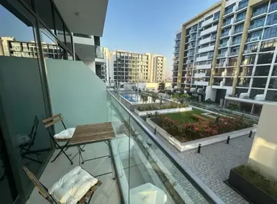 a balcony with a table and chairs on a building at Dubai Galaxy in Azizi Riviera Luxury Studio in Dubai
