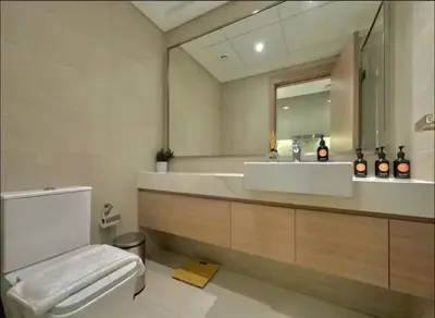 a bathroom with a sink and a toilet and a mirror at Dubai Galaxy in Azizi Riviera Luxury Studio in Dubai