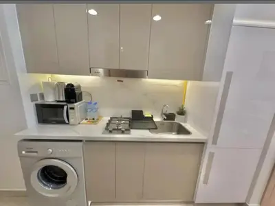 a small kitchen with a sink and a microwave at Dubai Galaxy in Azizi Riviera Luxury Studio in Dubai
