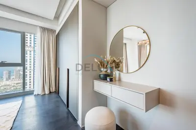 a dressing table and mirror in a white room with a window at Luxurious 2BR at DAMAC Heights, Dubai Marina by Deluxe Holiday Homes in Dubai