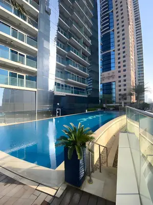 a swimming pool in a building with tall buildings at Luxurious 2BR at DAMAC Heights, Dubai Marina by Deluxe Holiday Homes in Dubai