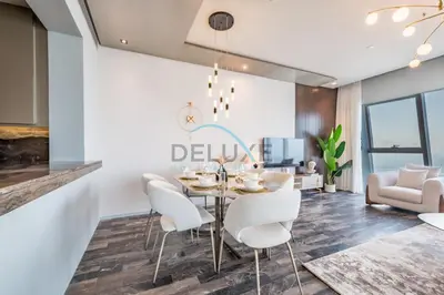 a dining room with a table and chairs at Luxurious 2BR at DAMAC Heights, Dubai Marina by Deluxe Holiday Homes in Dubai